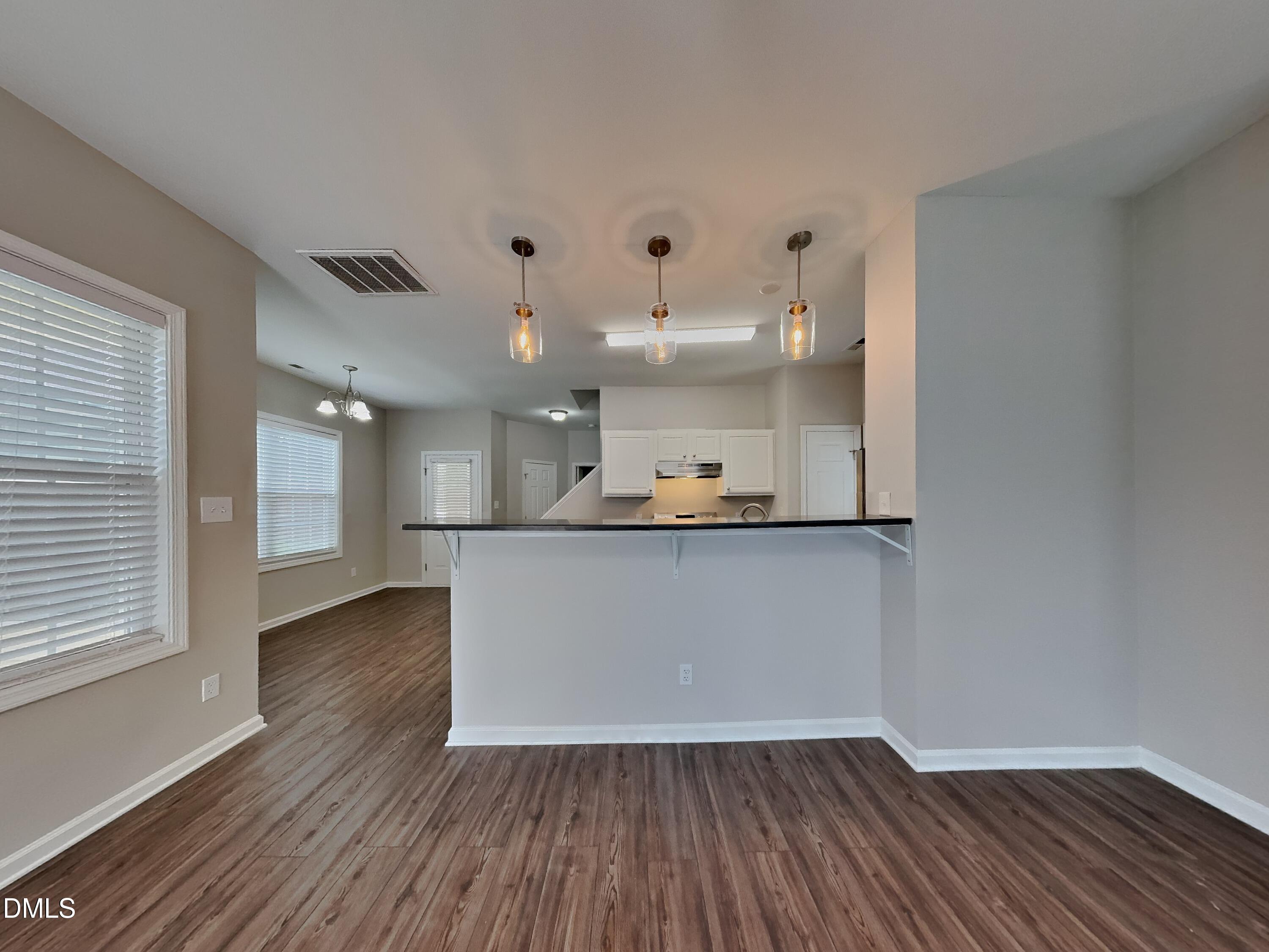 5816 Wynmore Road Raleigh, NC 27610 - Photo 3 of 18 a view of kitchen with wooden floor and windows