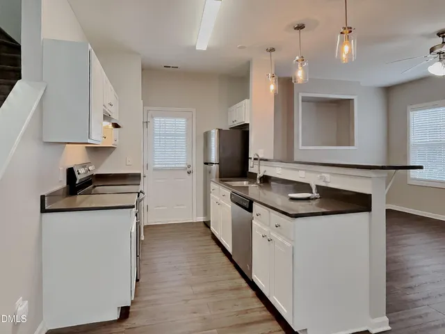 a kitchen with stainless steel appliances granite countertop a stove and a sink