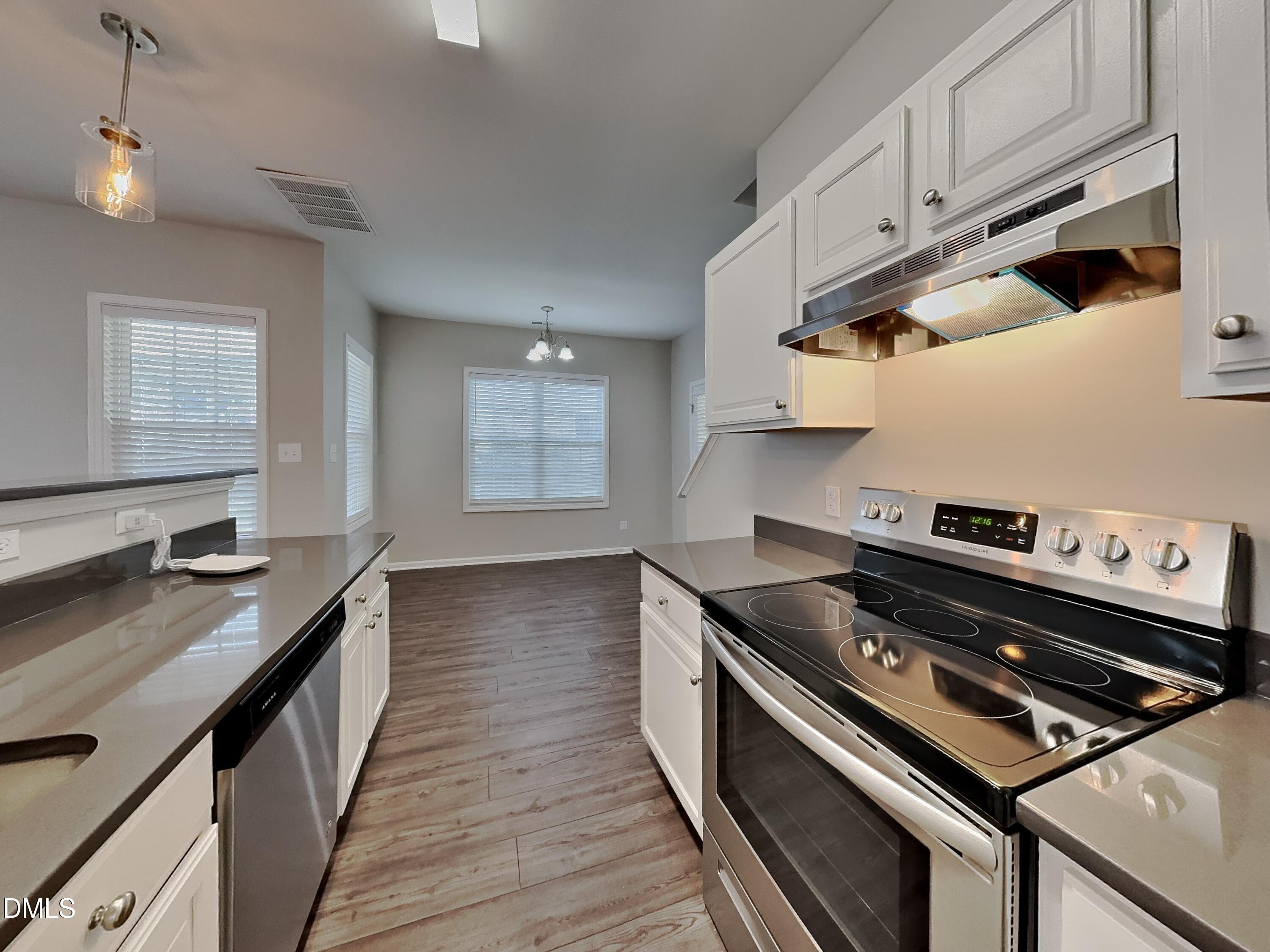 5816 Wynmore Road Raleigh, NC 27610 - Photo 6 of 18 a kitchen with a stove and a sink