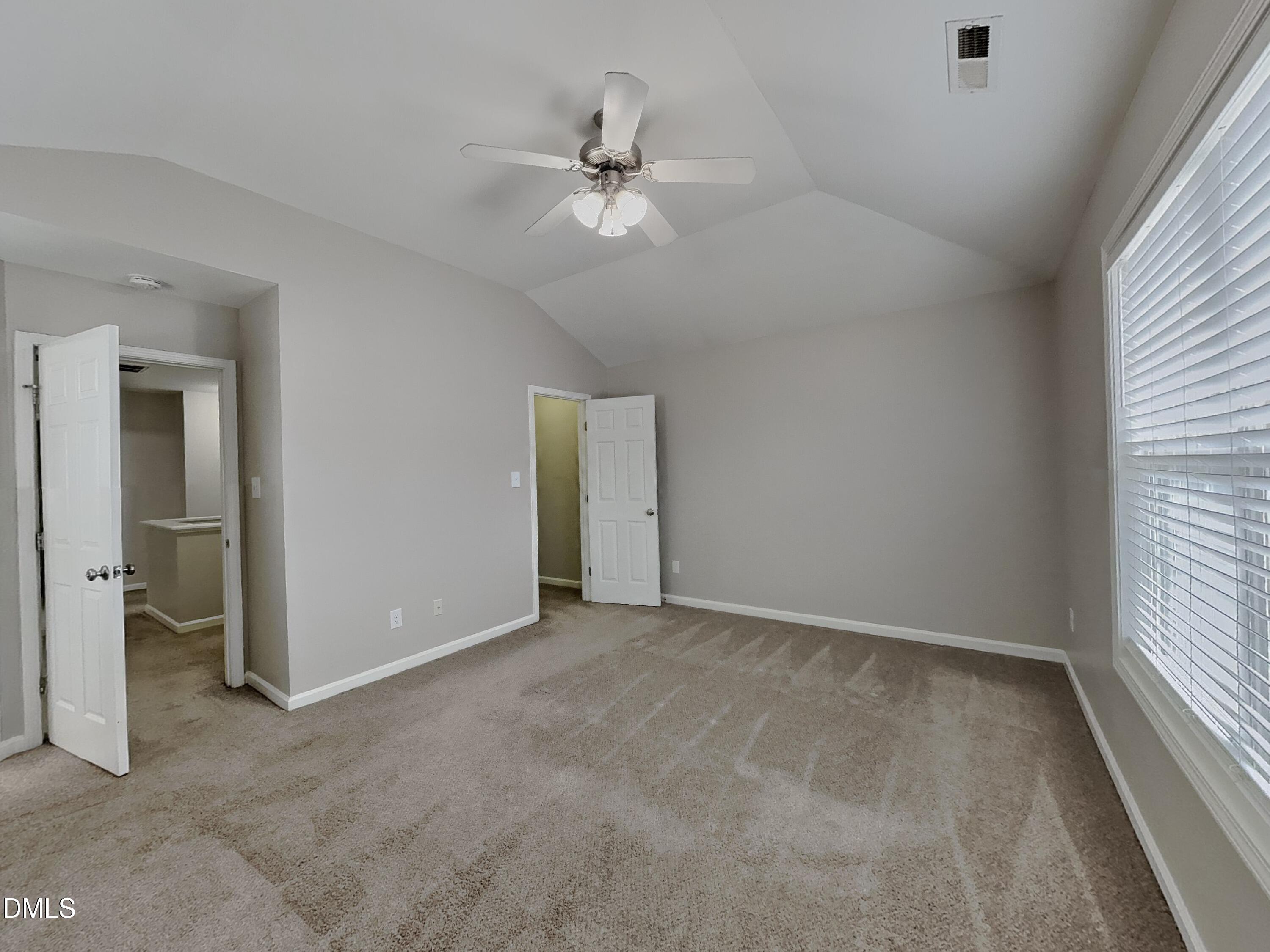 5816 Wynmore Road Raleigh, NC 27610 - Photo 8 of 18 an empty room with fan and windows