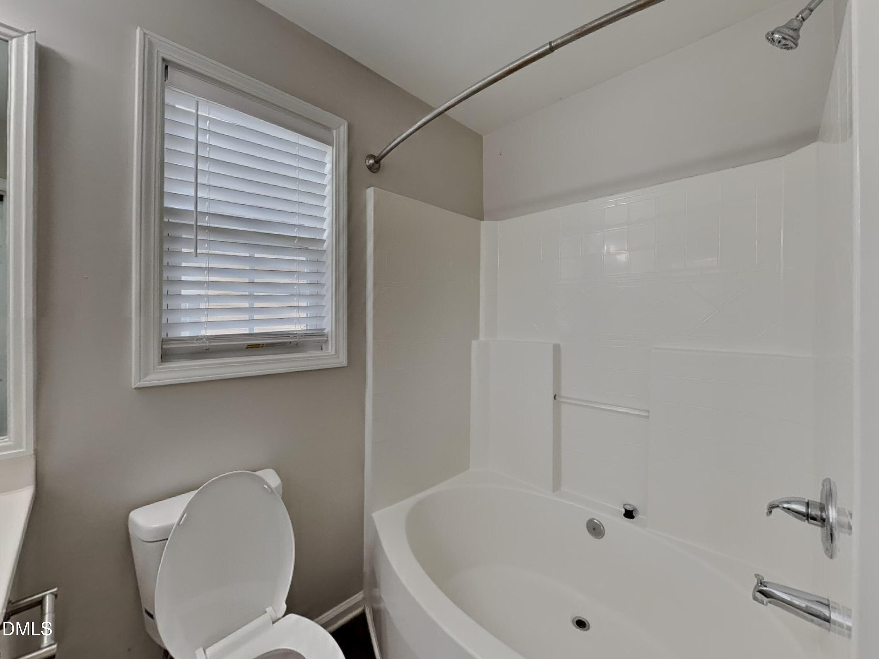 5816 Wynmore Road Raleigh, NC 27610 - Photo 10 of 18 a white bath tub sitting next to a white toilet