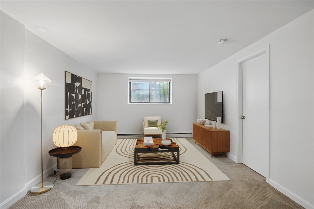 a living room with furniture a couch and a flat screen tv