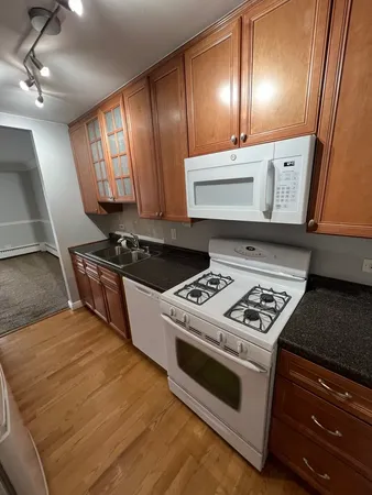 a kitchen with stainless steel appliances a stove a microwave and cabinets