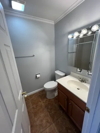 a bathroom with a sink a toilet and mirror