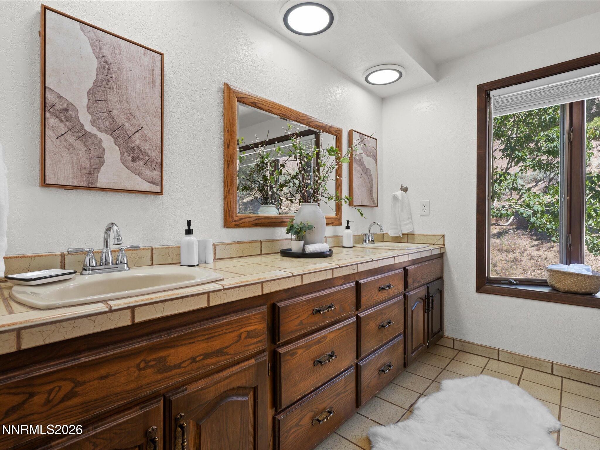 20449 Temelec Way Reno, NV 89521 - Photo 32 of 65 a bathroom with a granite countertop sink mirror and window