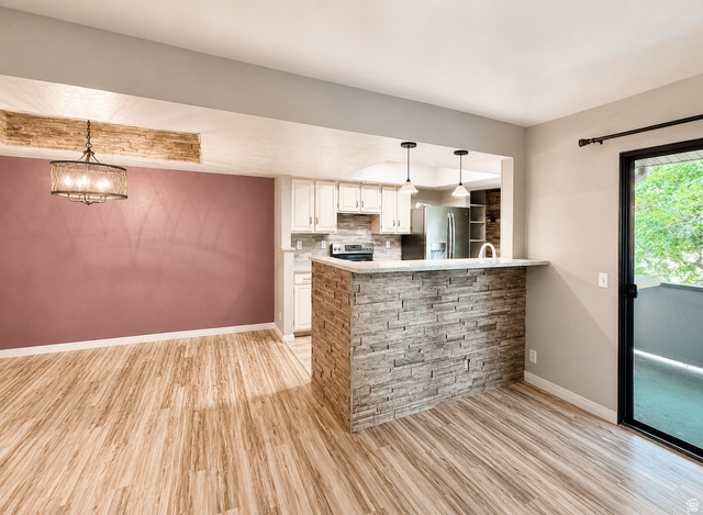 6907 South 745th Street East, Unit G Midvale, UT 84047 - Photo 8 of 30 Entertainer kitchen, dining, and living area