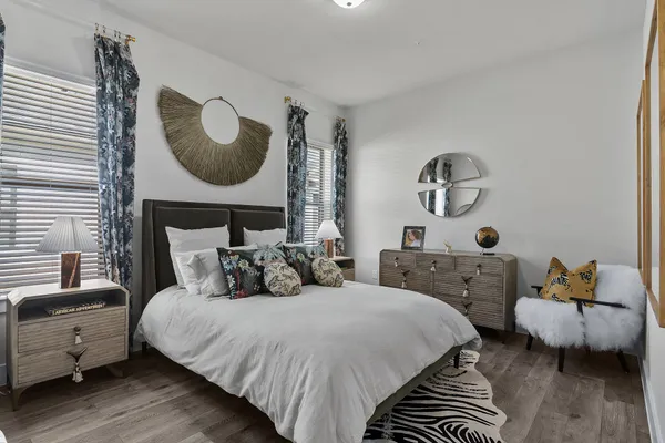 a bedroom with bed and a chair
