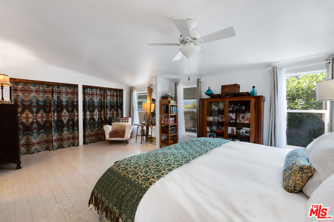 29500 Heathercliff Road, Unit 53 Malibu, CA 90265 - Photo 11 of 24 a bedroom with a large bed and a large window