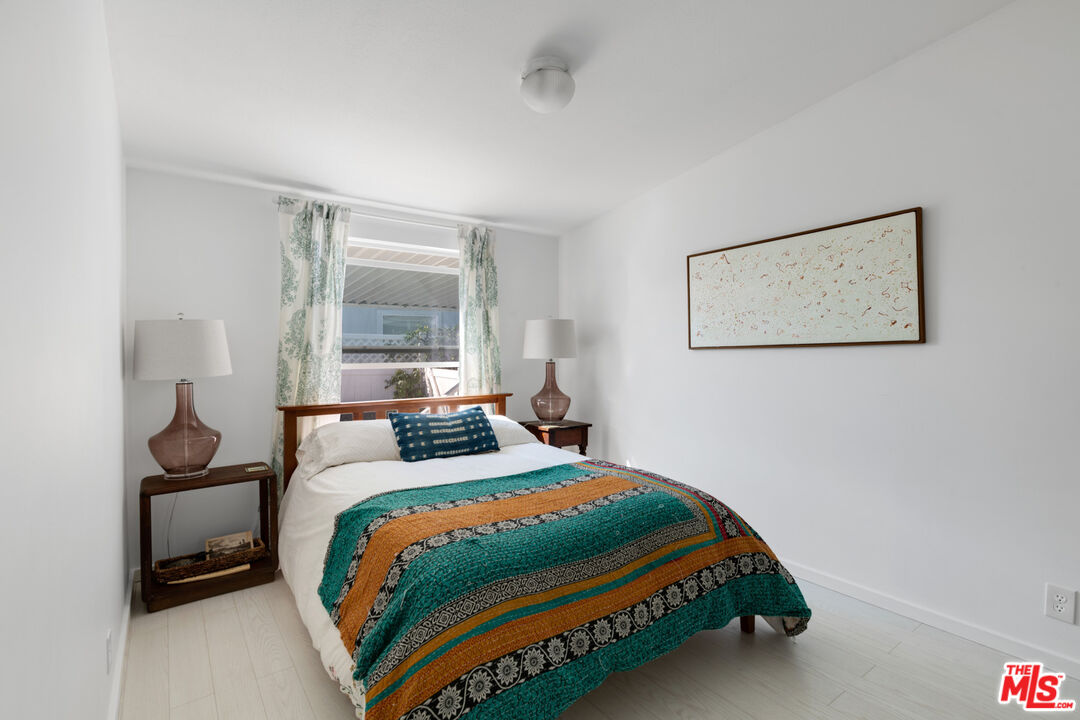 29500 Heathercliff Road, Unit 53 Malibu, CA 90265 - Photo 15 of 24 a bedroom with a bed and a painting on the wall