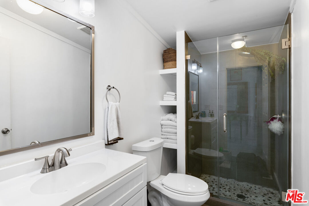 29500 Heathercliff Road, Unit 53 Malibu, CA 90265 - Photo 18 of 24 a bathroom with a sink toilet and shower