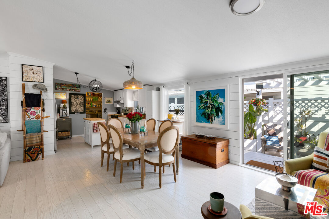 29500 Heathercliff Road, Unit 53 Malibu, CA 90265 - Photo 7 of 24 a dining room with furniture and a chandelier