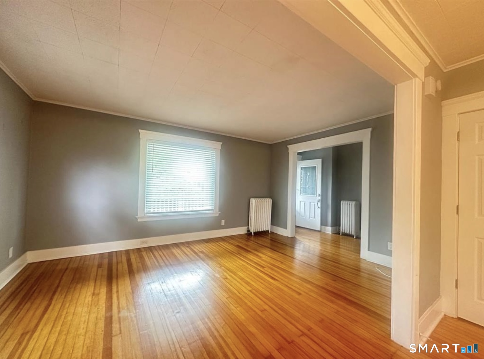 49 Dutton Street Wallingford, CT 06492 - Photo 6 of 10 an empty room with wooden floor and windows
