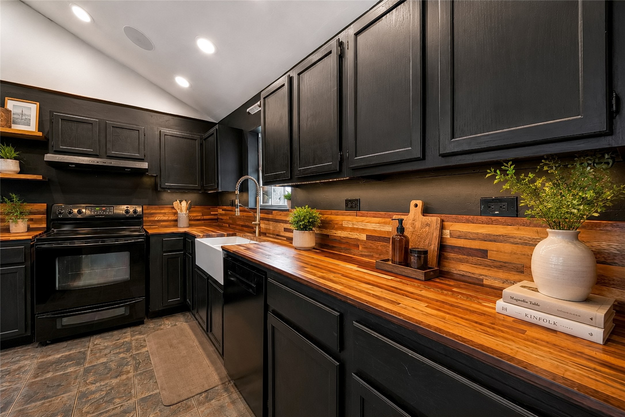 358 Easley Road Smithville, TX 78957 - Photo 9 of 36 Virtually staged - Kitchen with crafted wooden countertops and sleek black cabinetry define this functional culinary space.