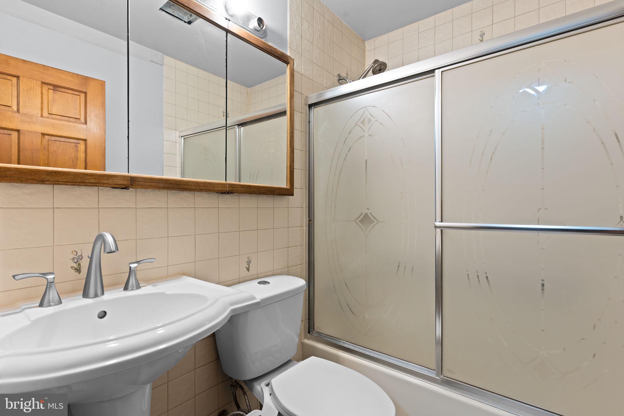 212 Plumbridge Drive Levittown, PA 19056 - Photo 11 of 19 a bathroom with a sink toilet and shower