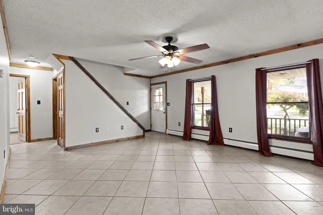 a kitchen with stainless steel appliances granite countertop a refrigerator a sink dishwasher a stove with wooden cabinets and floor