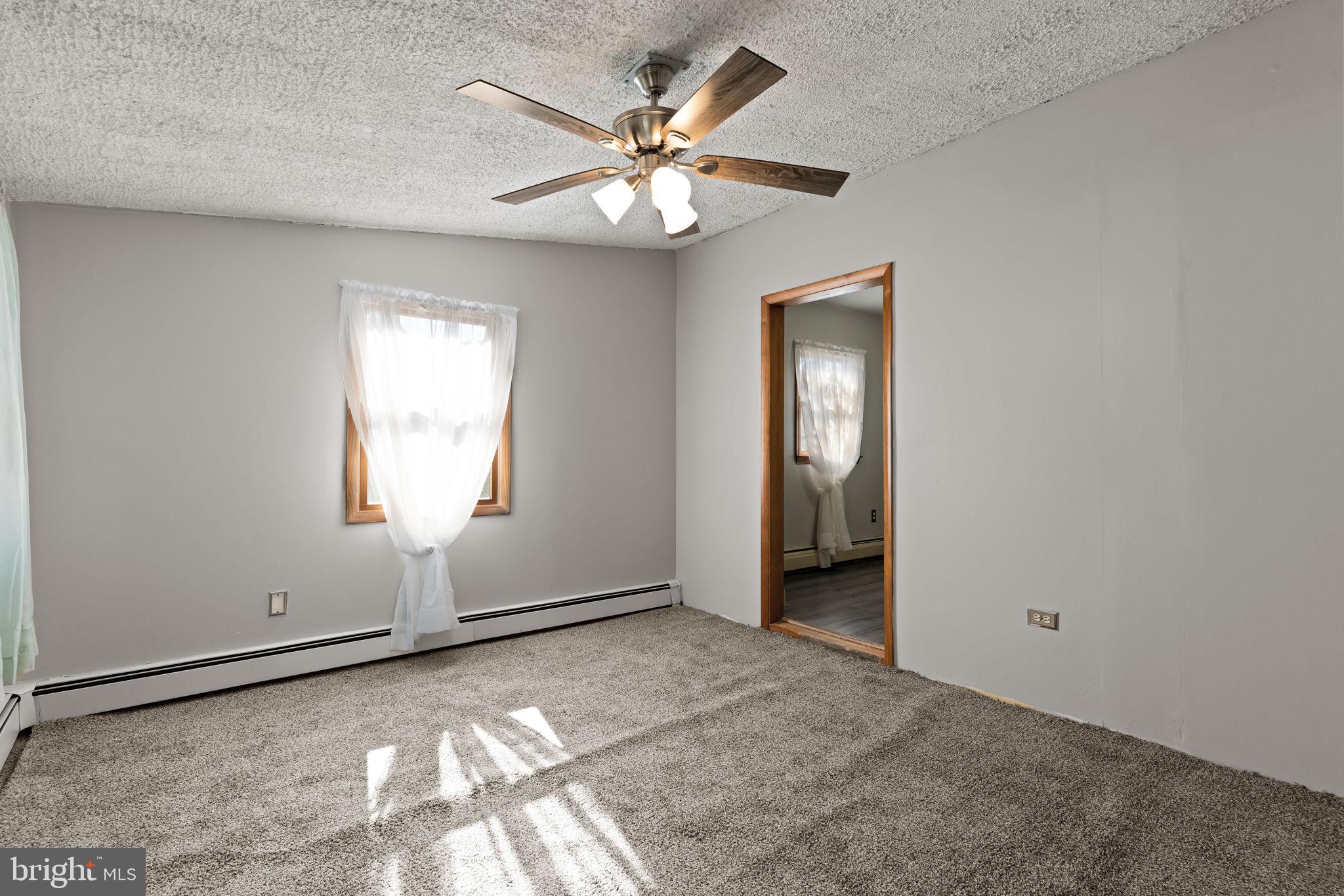 212 Plumbridge Drive Levittown, PA 19056 - Photo 8 of 19 an empty room with fan and windows