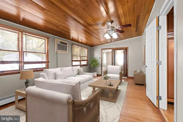 an empty room with fan and windows