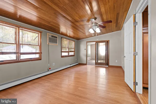 wooden floor in an empty room with a window