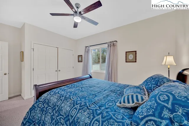 a bedroom with a large bed and a chandelier