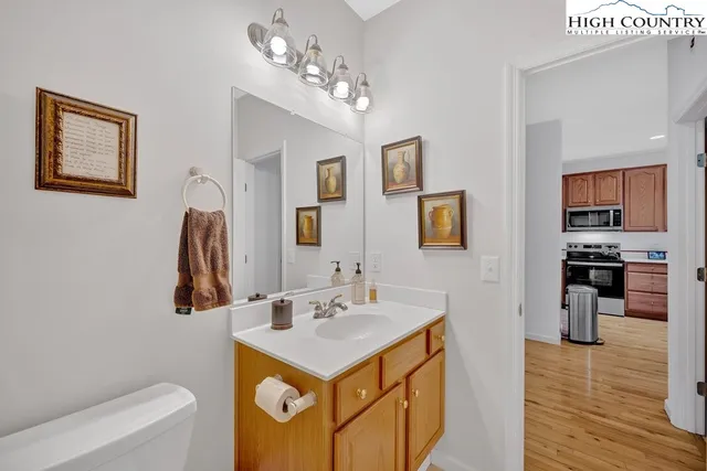 a bathroom with a sink a mirror and a toilet