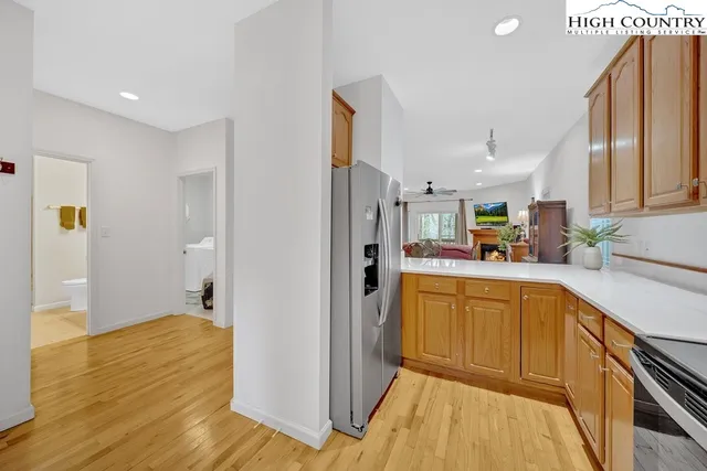 a kitchen with cabinets and wooden floor
