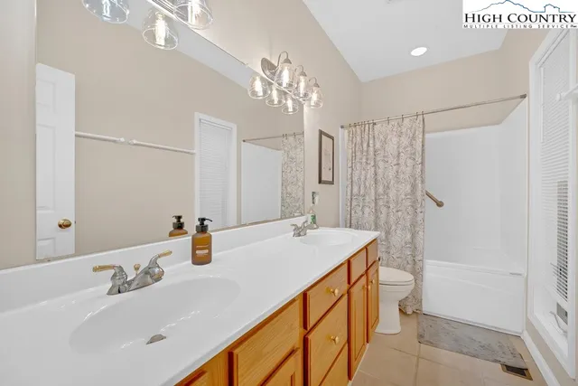 a bathroom with a sink double vanity and a mirror