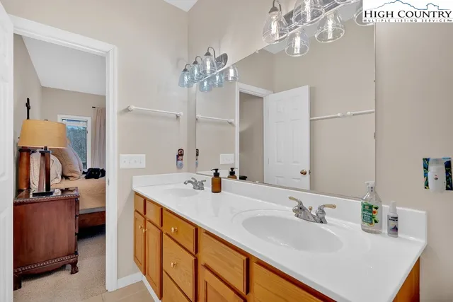 a bathroom with a sink double vanity and a mirror