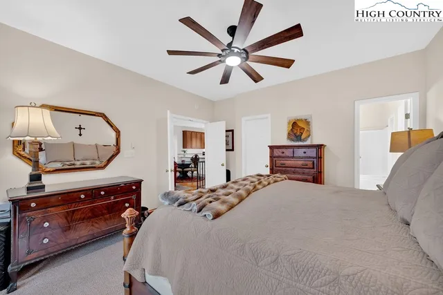 a bedroom with a bed and ceiling fan
