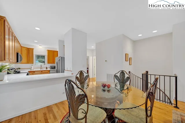 a view of a a dining room with furniture window and wooden floor