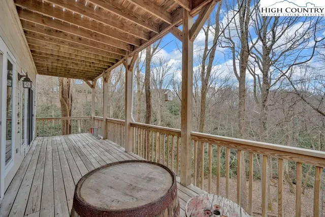 a view of balcony with wooden floor and fence