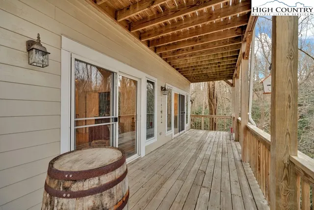 a view of a room with wooden floor and iron stairs