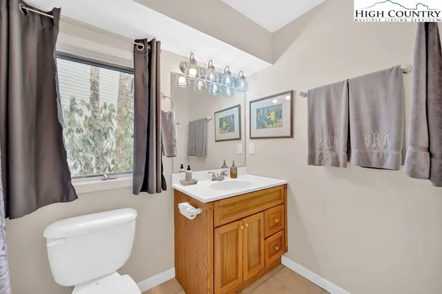 a bathroom with a sink a toilet a mirror and a tub