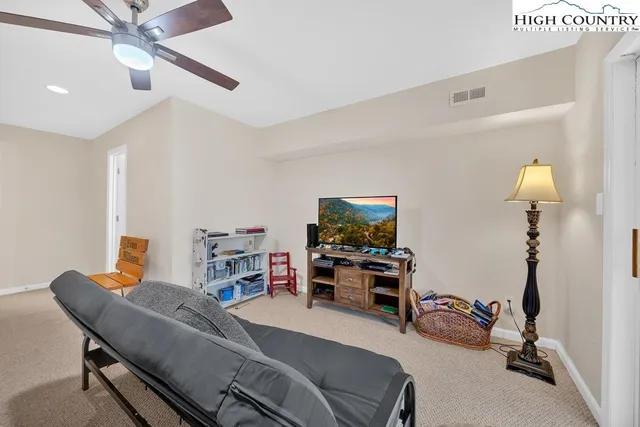 a bedroom with furniture and a flat screen tv