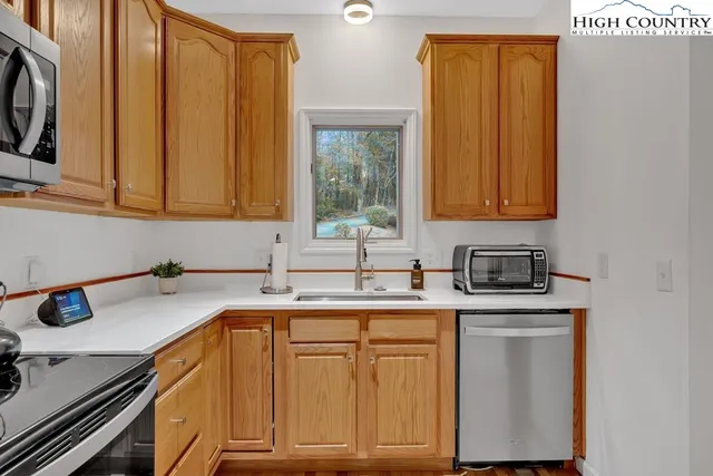 a kitchen with a sink cabinets and appliances