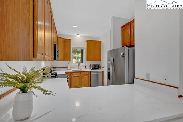 a view of a kitchen with a sink and living room