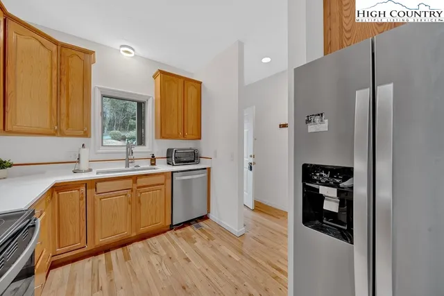 a kitchen with stainless steel appliances granite countertop a refrigerator and a sink