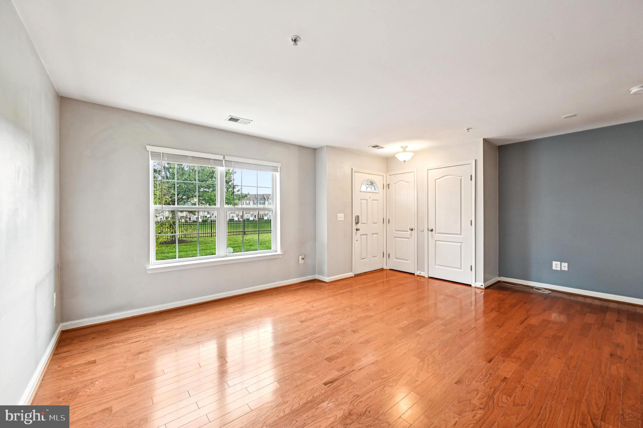 6467 Cornwall Drive, Unit 56 Eldersburg, MD 21784 - Photo 15 of 35 a view of an empty room with wooden floor and a window