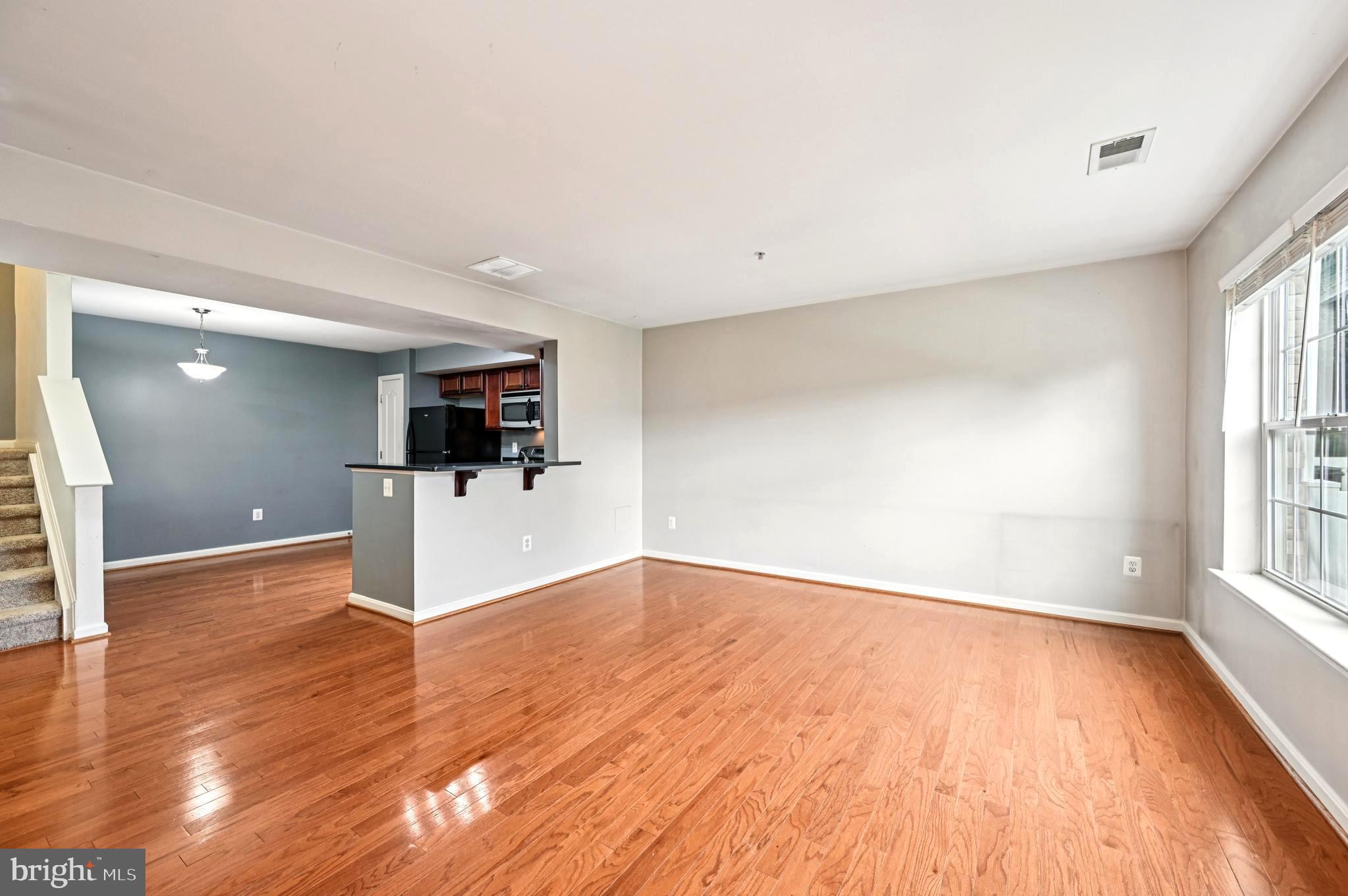 6467 Cornwall Drive, Unit 56 Eldersburg, MD 21784 - Photo 16 of 35 wooden floor in an empty room with a window