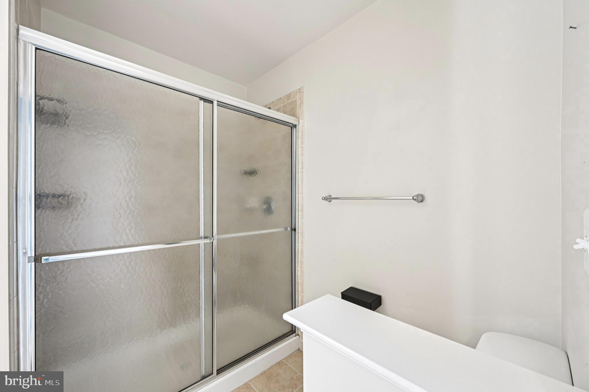 6467 Cornwall Drive, Unit 56 Eldersburg, MD 21784 - Photo 24 of 35 a bathroom with a bathtub and shower