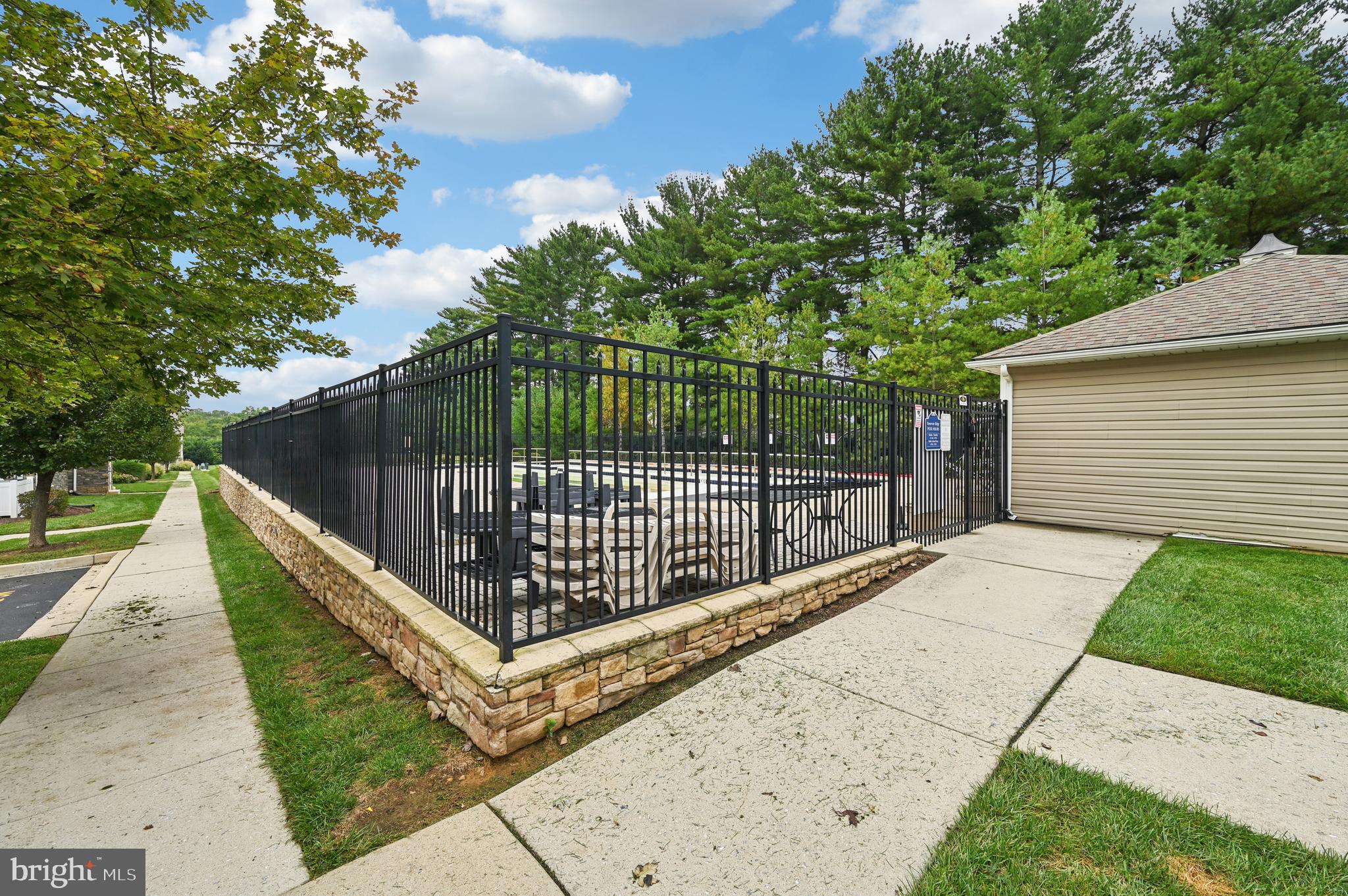 6467 Cornwall Drive, Unit 56 Eldersburg, MD 21784 - Photo 30 of 35 a view of a backyard with a trees