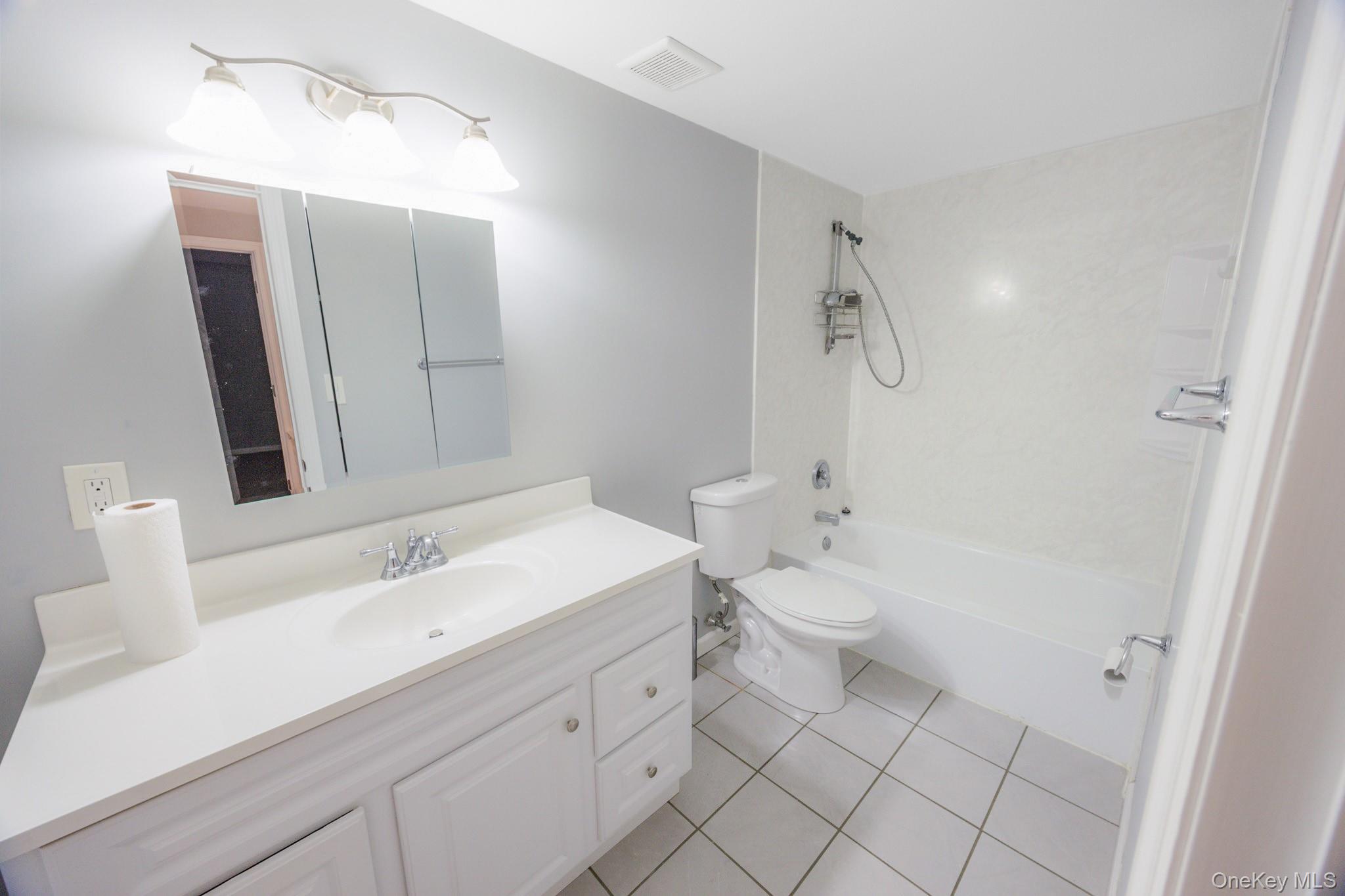 100 Glen Hollow Drive Port Jefferson Station, NY 11776 - Photo 11 of 21 a bathroom with a double vanity sink mirror and toilet