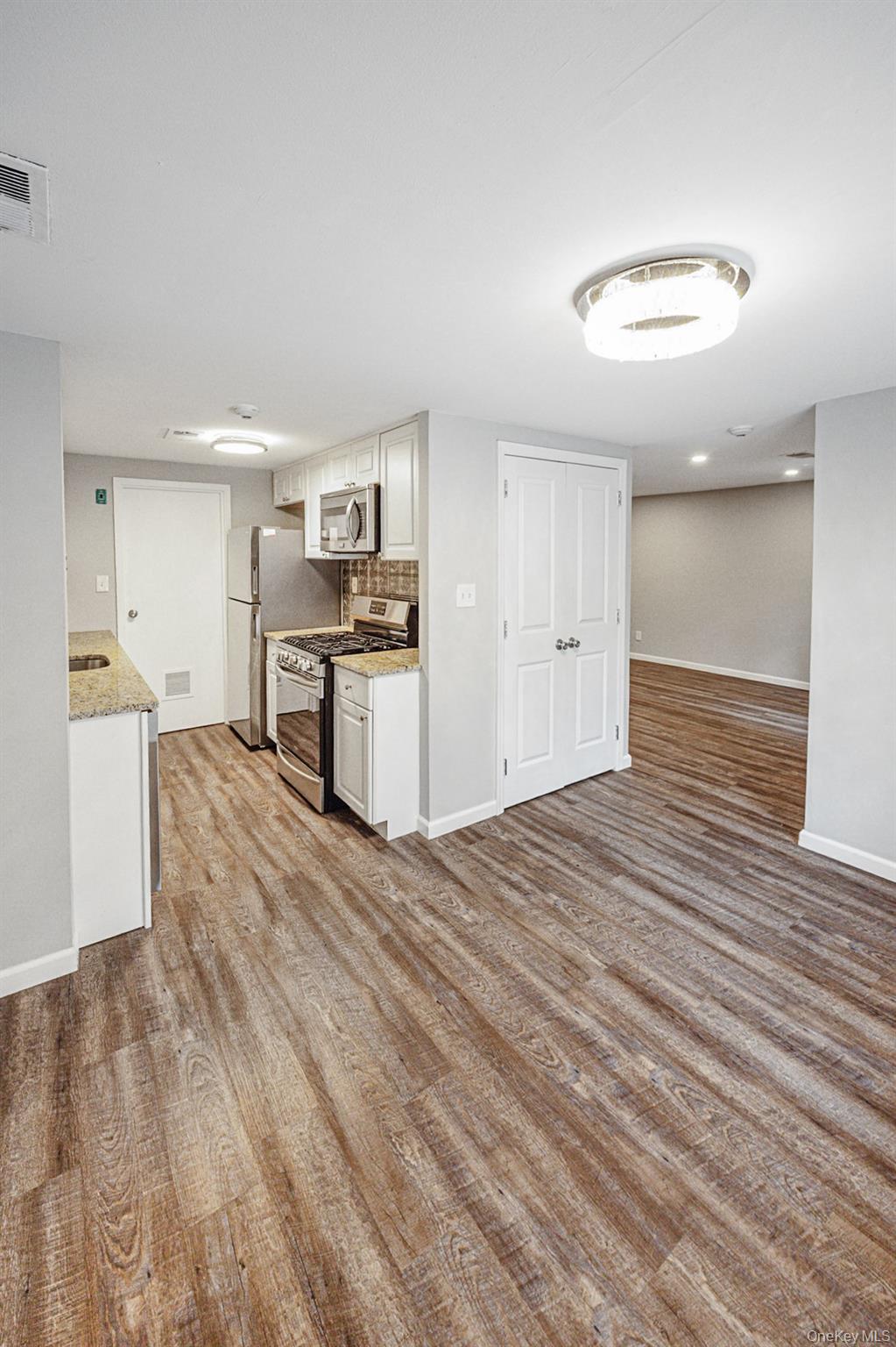 100 Glen Hollow Drive Port Jefferson Station, NY 11776 - Photo 12 of 21 a view of a kitchen with a sink and a refrigerator