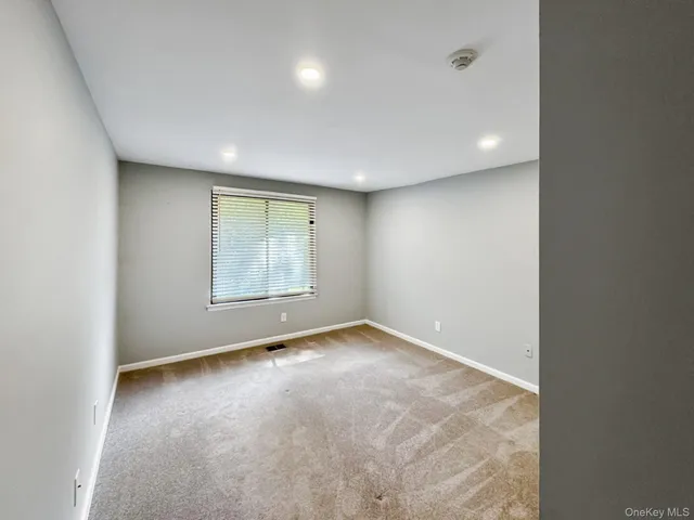an empty room with a empty space and windows
