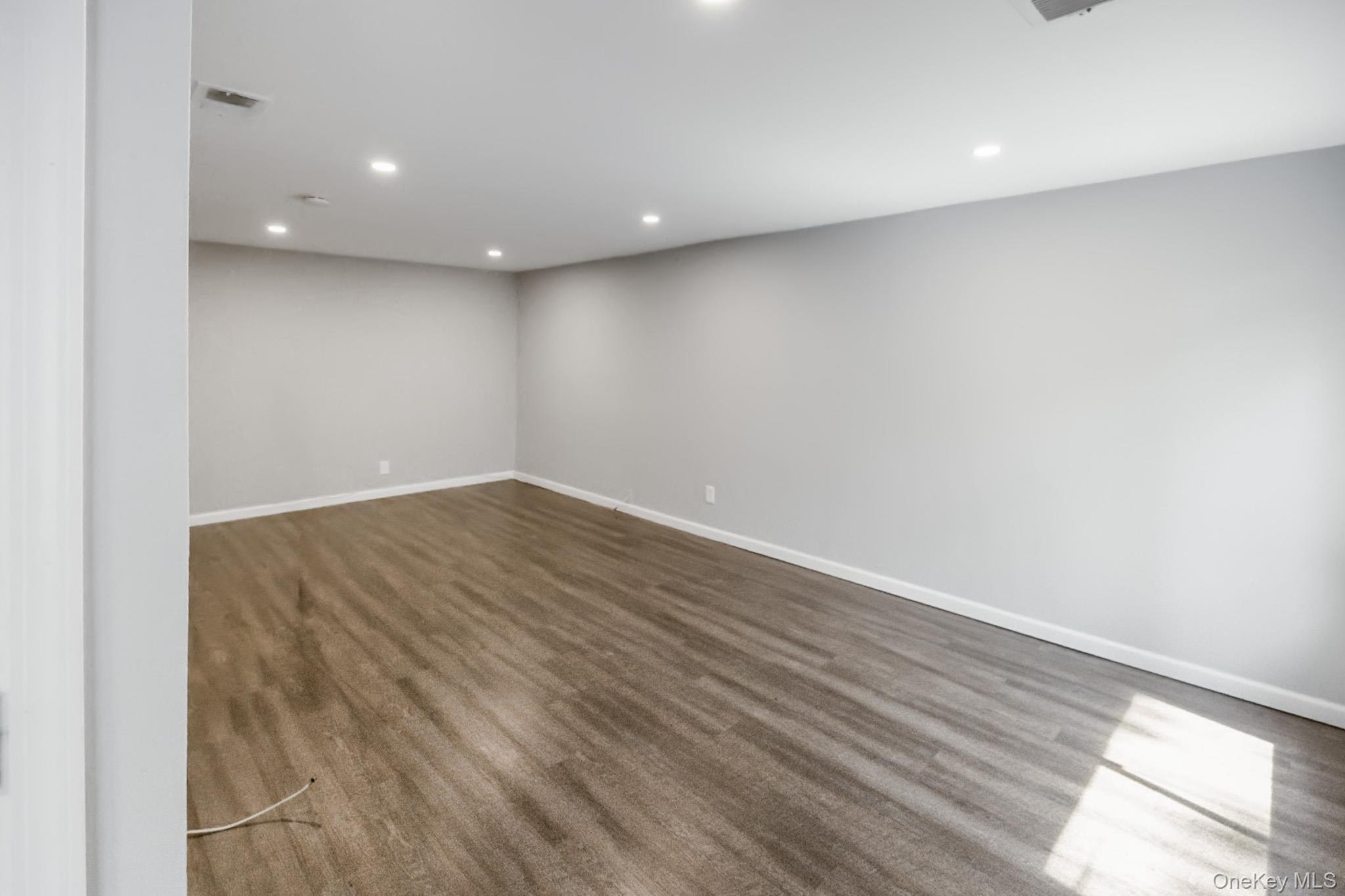 100 Glen Hollow Drive Port Jefferson Station, NY 11776 - Photo 6 of 21 a view of room with wooden floor and windows
