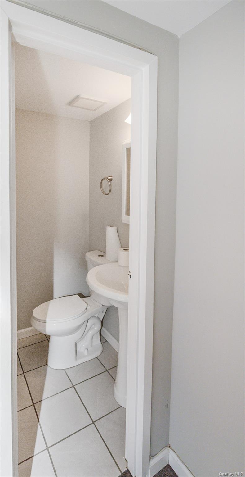 100 Glen Hollow Drive Port Jefferson Station, NY 11776 - Photo 9 of 21 a white toilet sitting next to a bathroom sink