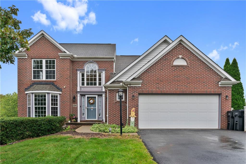a front view of a house with a yard and garage