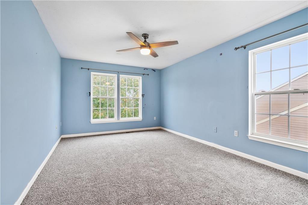 11580 Percheron Circle Irwin, PA 15642 - Photo 19 of 26 an empty room with windows and ceiling fan