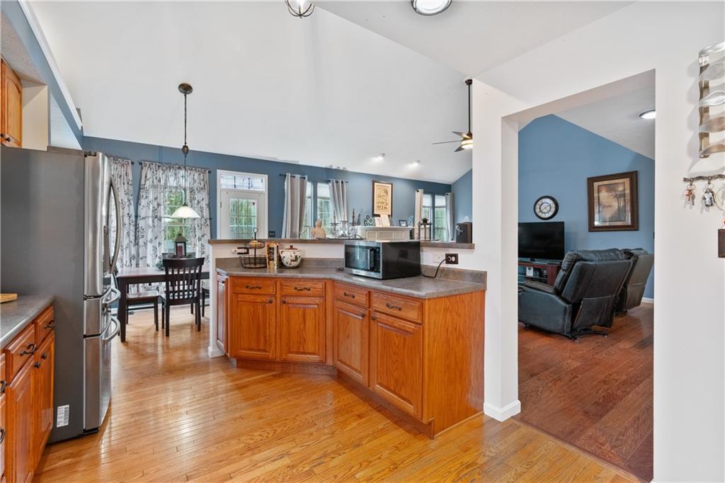 11580 Percheron Circle Irwin, PA 15642 - Photo 4 of 26 a large kitchen with a table chairs refrigerator and cabinets