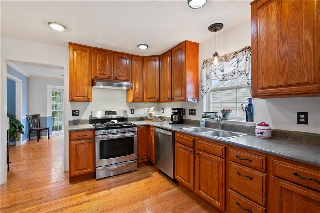 11580 Percheron Circle Irwin, PA 15642 - Photo 5 of 26 a kitchen with stainless steel appliances granite countertop wooden cabinets a sink and a stove
