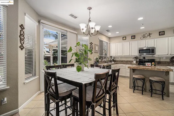 a kitchen with a refrigerator a stove a sink and cabinets